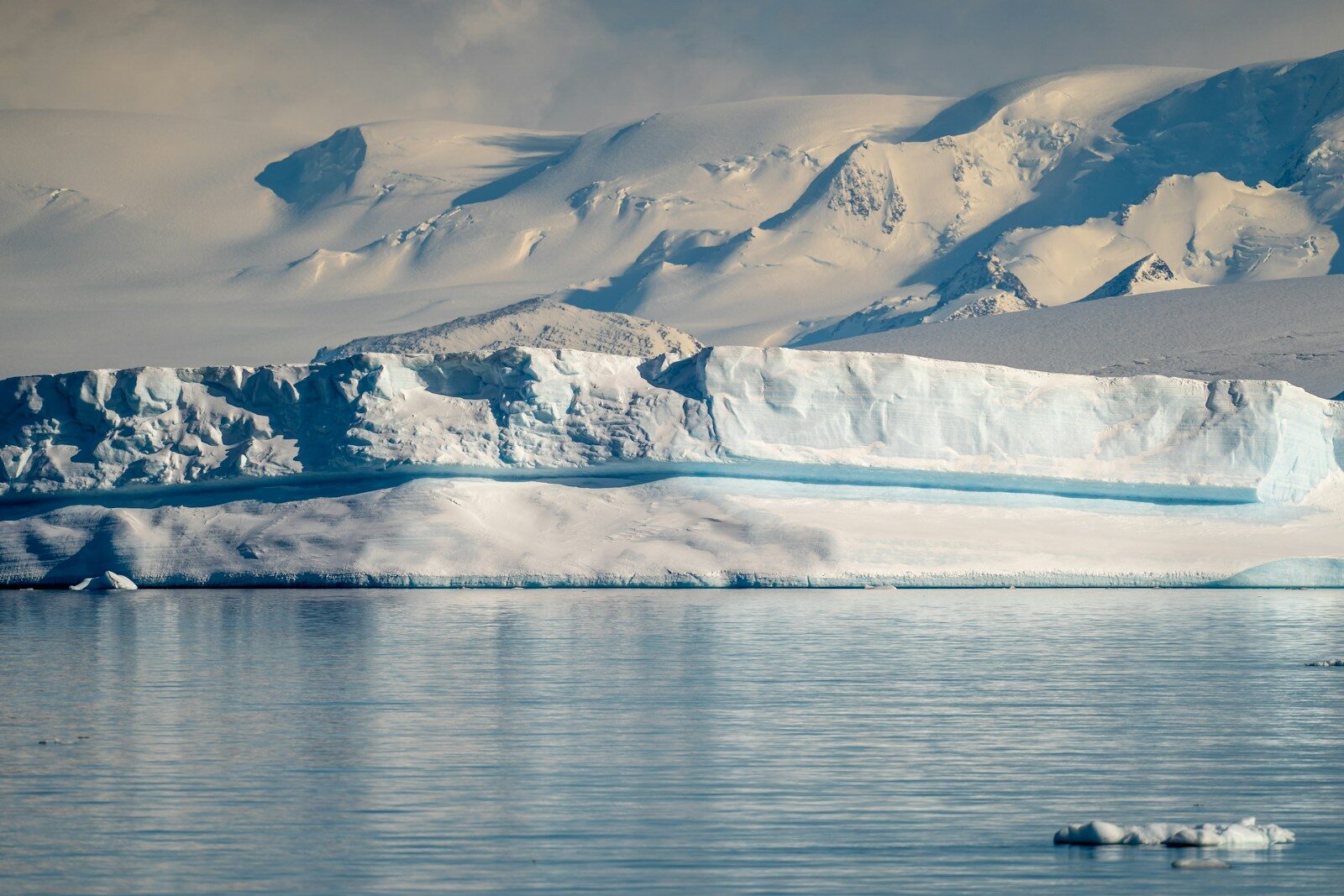 a large iceberg floating in the middle of a lake